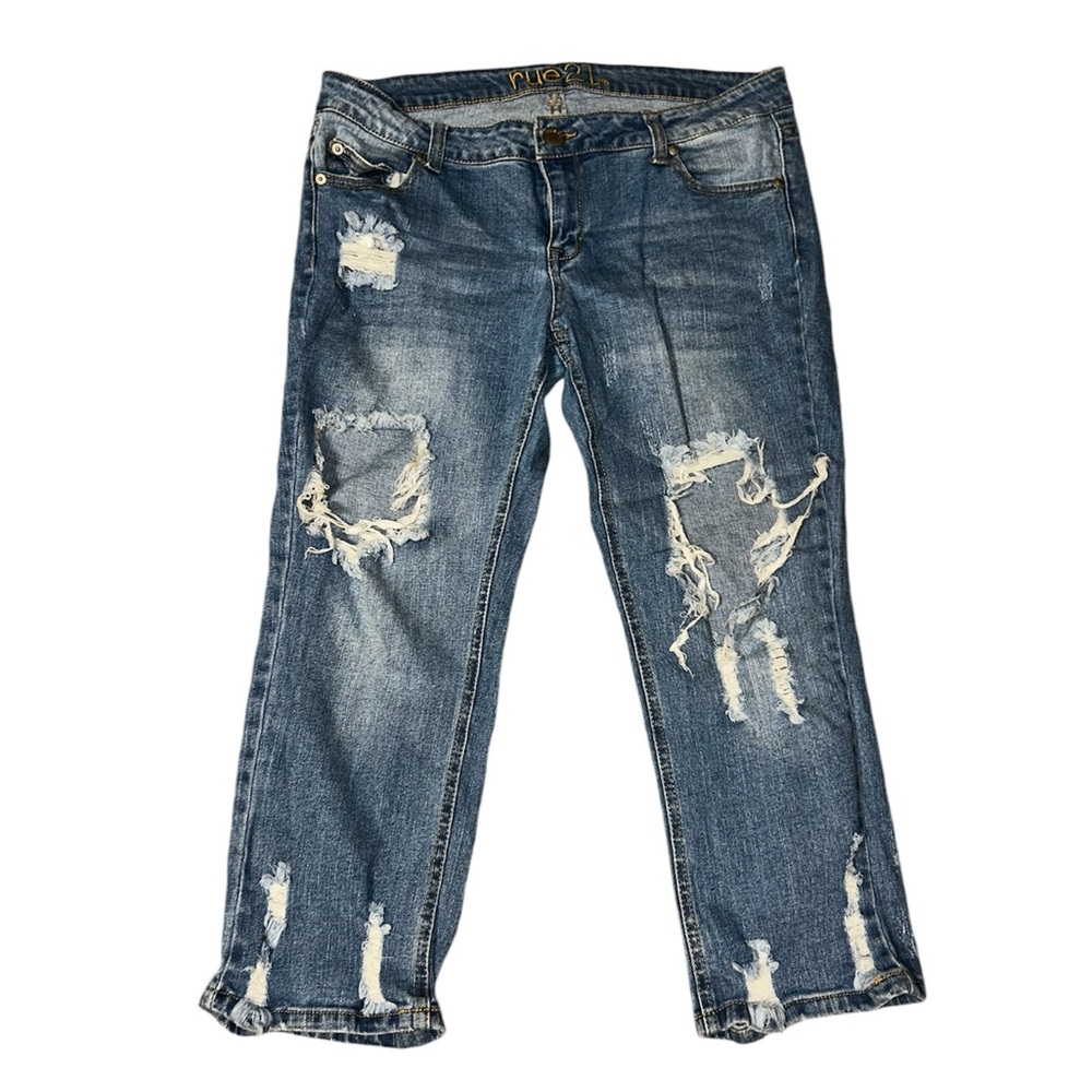 Blue distressed denim jeans with ripped knees